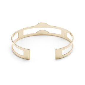 Edgy, lightweight, and adjustable cuff bracelet of polished brass, with three rectangular cutouts through the center of the cuff and two semicircle-shaped peaks at the front of the cuff. Hand-crafted in Portland, Oregon.