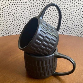 Wheel thrown hand carved mug with a matte black finish. Handmade by Amy A ceramics in Portland, Oregon.