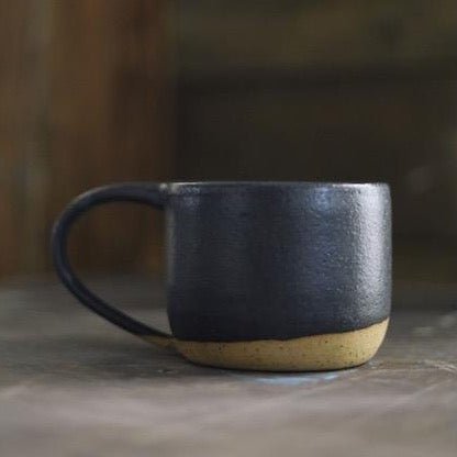 Wheel thrown mug made with speckled stoneware clay and fired with a black matte glaze. Handmade by Amy A Ceramics and handmade in Portland, Oregon.