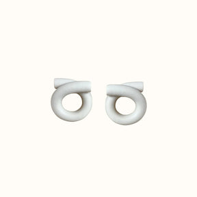 Polymer clay stud earrings in a loop formation and off-white color. The Medium Loop Earrings inCream are designed and handcrafted by Little Pieces Jewelry in Los Angeles, California.