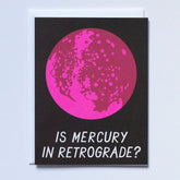 Bright pink planet against a black background. Front of card reads: "IS MERCURY IN RETROGRADE?" Made with recycled paper by Banquet Atelier in Vancouver, British Columbia, Canada.