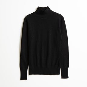 A long sleeve knitted mock neck turtleneck in black. The Merino Turtleneck in Black is designed by Dinadi and hand knitted in Kathmandu, Nepal. 