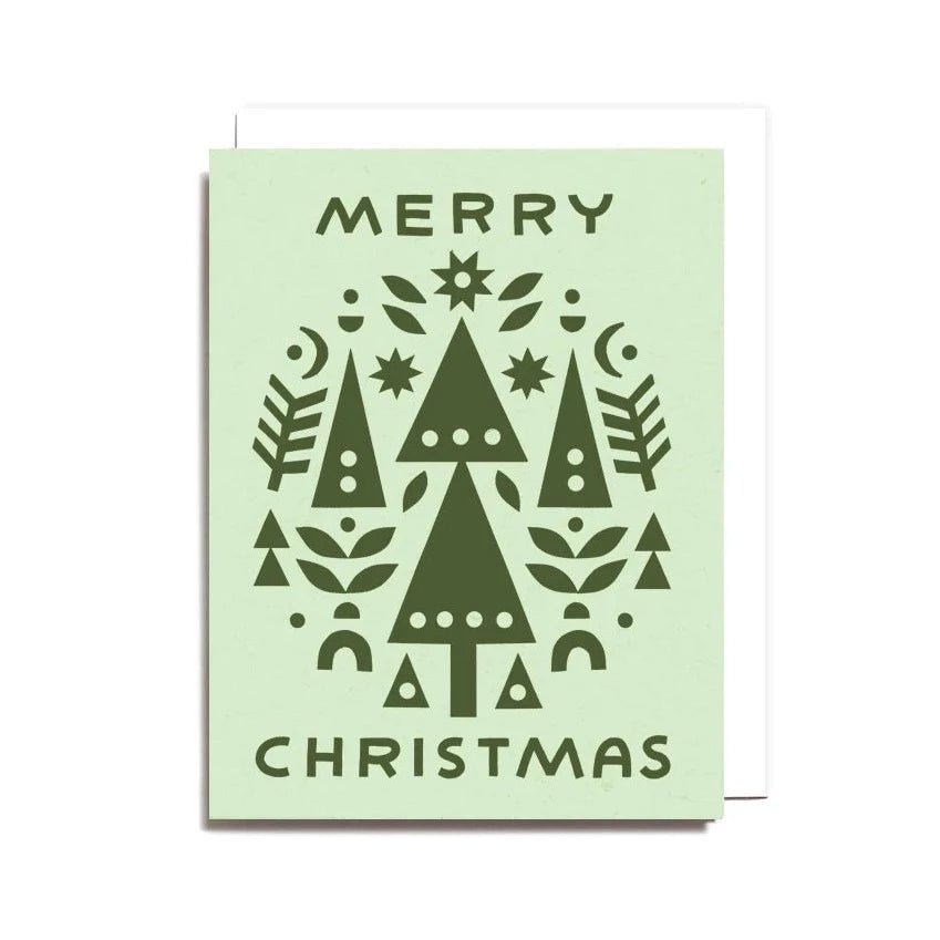 A light green card with a dark green paper cut Christmas collage design. Front of card reads: "MERRY CHRISTMAS." Designed and handcrafted by Worthwhile Paper in Ypsilanti, MI.
