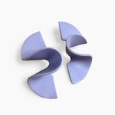 A wide band polymer clay stud earring in a wave design. The Modern Wave Earrings in Lilac are designed and handcrafted by Little Pieces Jewelry in Los Angeles, California.