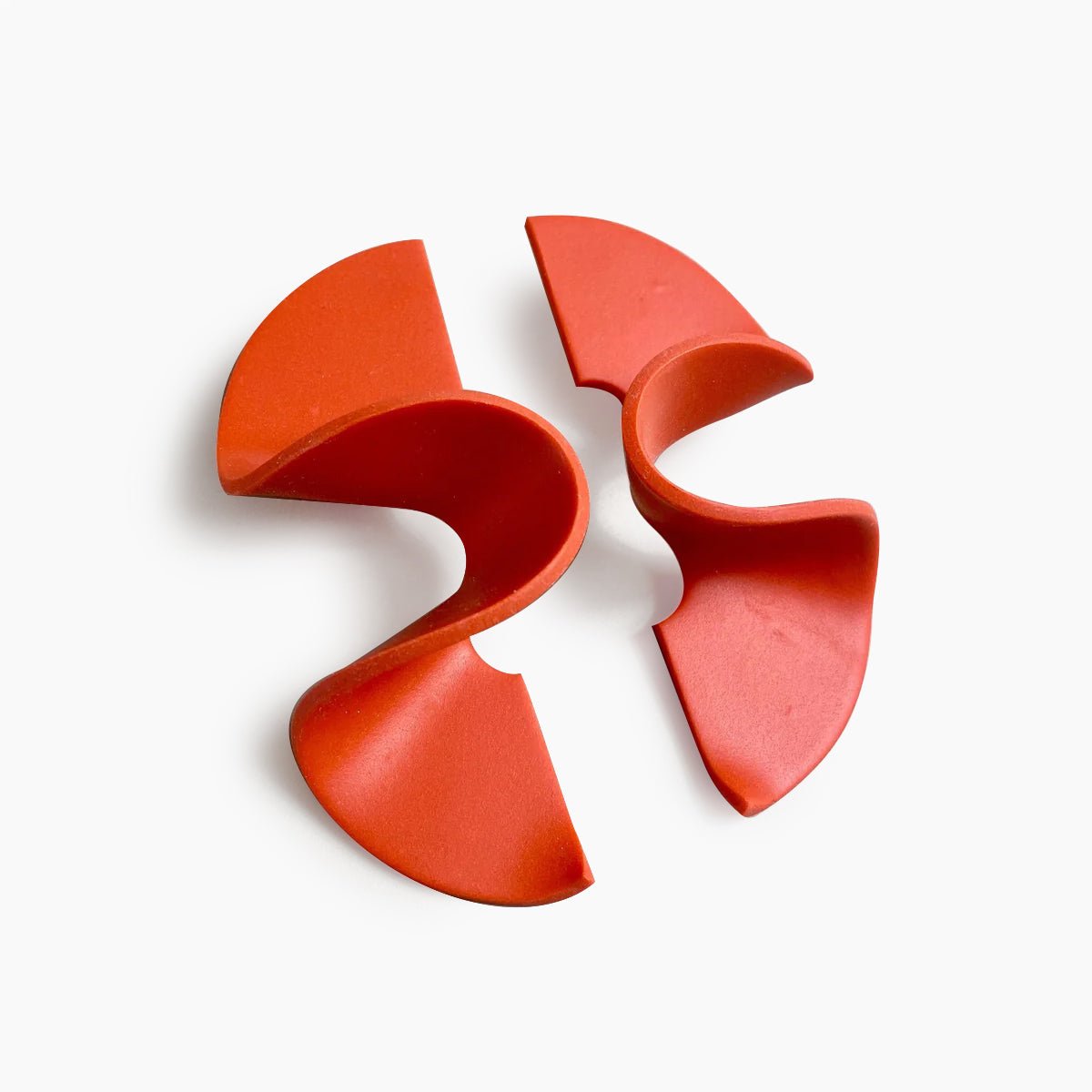 A wide band polymer clay stud earring in a wave design. The Modern Wave Earrings in Poppy are designed and handcrafted by Little Pieces Jewelry in Los Angeles, California.