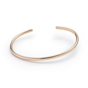 Classic, simple, and adjustable stacking cuff of hand-forged brass wire, with etched notch details on both ends of the cuff. Hand-crafted in Portland, Oregon.
