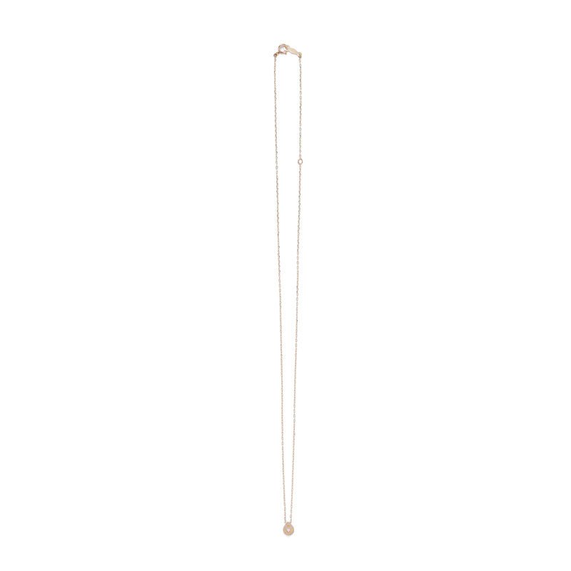 Tiny, circular pendant of 14k yellow gold, with subtle engraved details around a small white diamond, on a 14k gold chain with spring-ring clasp. Hand-crafted in Portland, Oregon. 