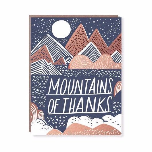 Front of card reads: "MOUNTAINS OF THANKS." Card displays mountains and rolling hills in blue, white and pale red under a moon and starry sky. Designed by Hello! Lucky and made in San Francisco, CA. Measures 4.25 x 5.5 inches.