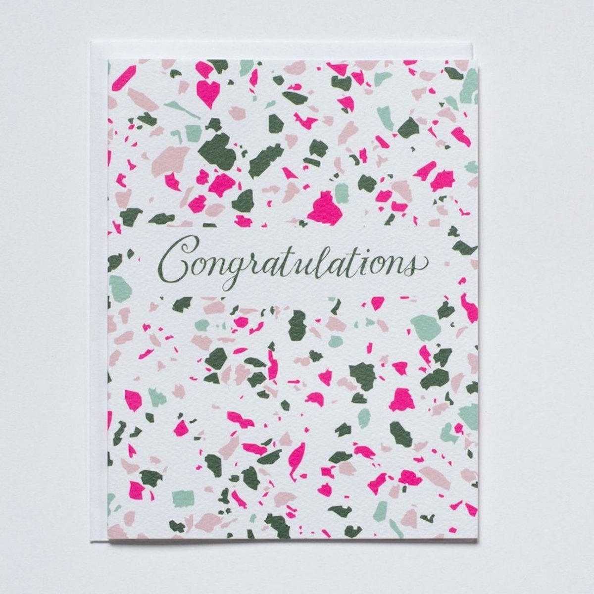 White card with pink and green terrazzo pattern that reads: "CONGRATULATIONS" in green script. Made with recycled paper by Banquet Atelier in Vancouver, British Columbia, Canada.