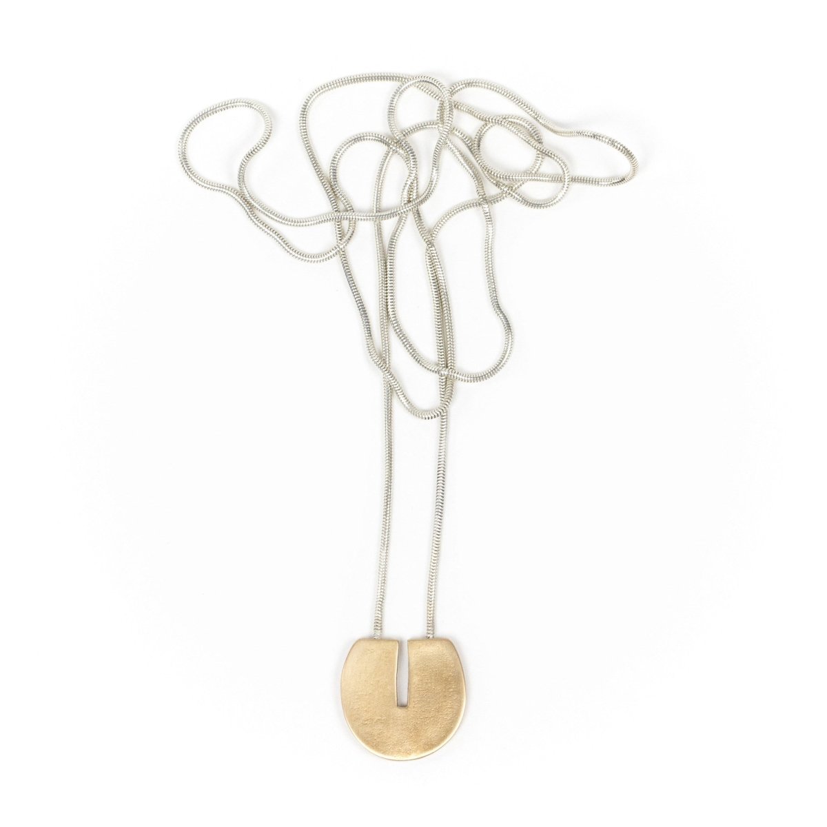Circular, cast-bronze pendant with a flat top and rectangular cutout that starts at the top and runs halfway through the center of the circle, threaded through the back of the pendant with a long, sterling silver snake chain. Hand-crafted in Portland, Oregon. 