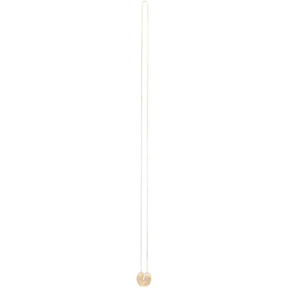 Circular, cast-bronze pendant with a flat top and rectangular cutout that starts at the top and runs halfway through the center of the circle, threaded through the back of the pendant with a long, sterling silver snake chain. Hand-crafted in Portland, Oregon. 