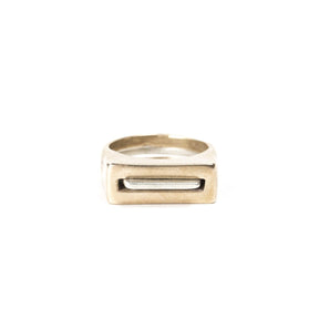 A pair of contemporary rings, featuring one thin, silver ring with an elongated curve (Tuyo) fitted through a chunky, bronze ring with a rectangular cutout (Mía). Hand-crafted in Portland, Oregon. 