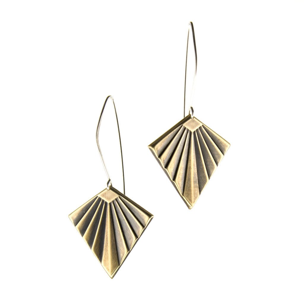 Gold deco shape earrings hang on silver wires.