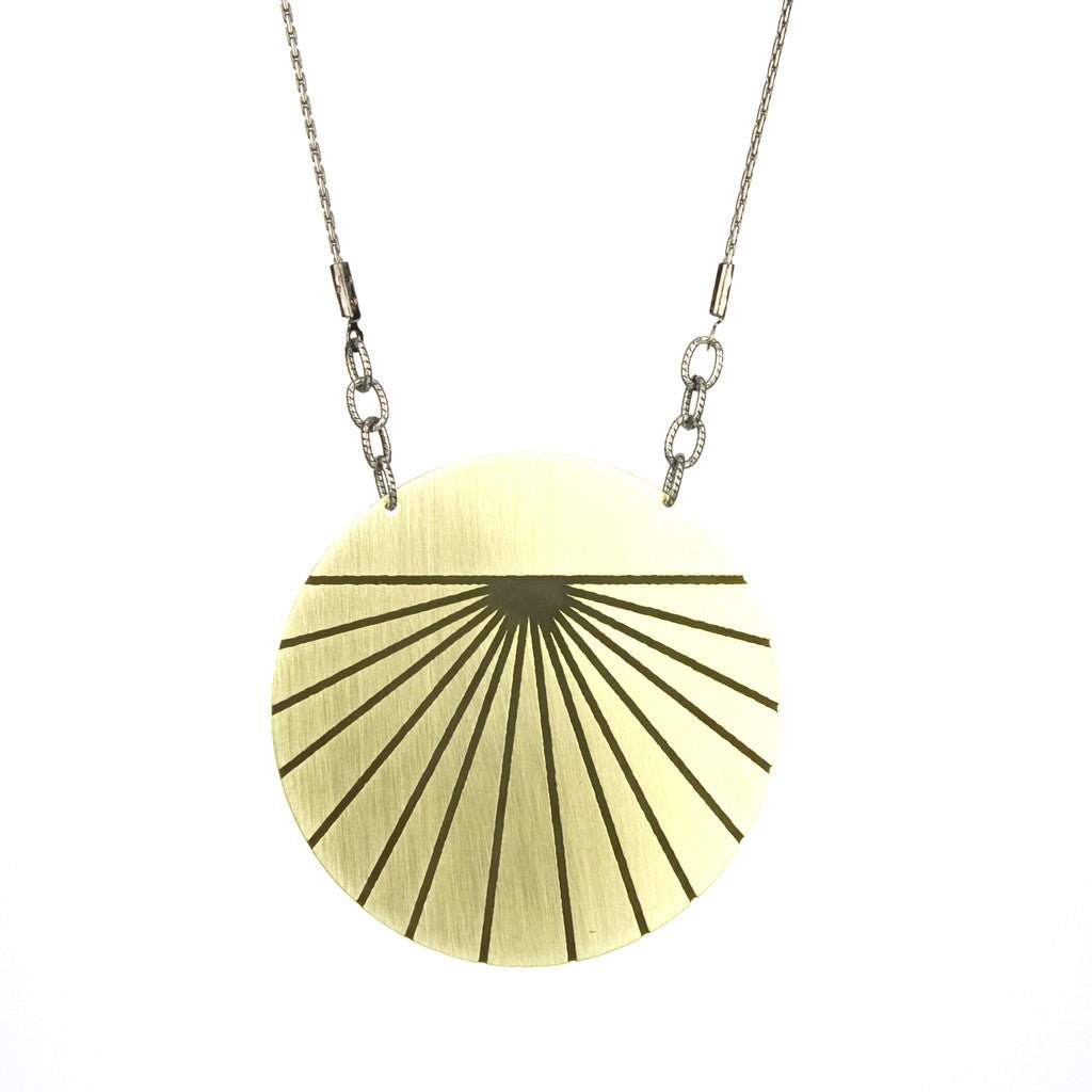 Mid-length simple gold pendant necklace.