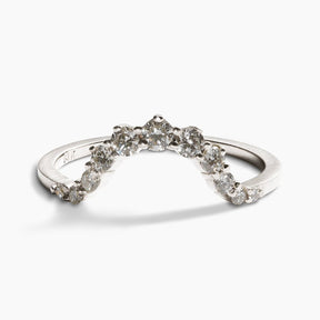 Arched Ortus ring, with prong set lab-grown diamonds. This contoured stacking band is made of 14K recycled white gold.