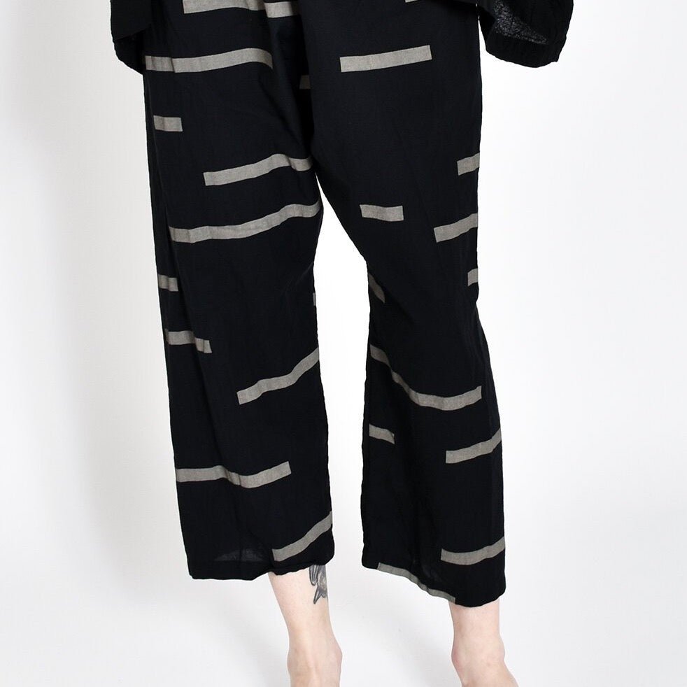 Loose fitting straight leg cropped black pants with light grey horizontal stripe pattern. Designed and sewn by Uzi in Brooklyn, New York.
