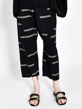 Loose fitting straight leg cropped black pants with light grey horizontal stripe pattern. Designed and sewn by Uzi in Brooklyn, New York.