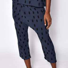 Loose fitting straight leg cropped navy blue pants with black square pattern. Designed and sewn by Uzi in Brooklyn, New York. 