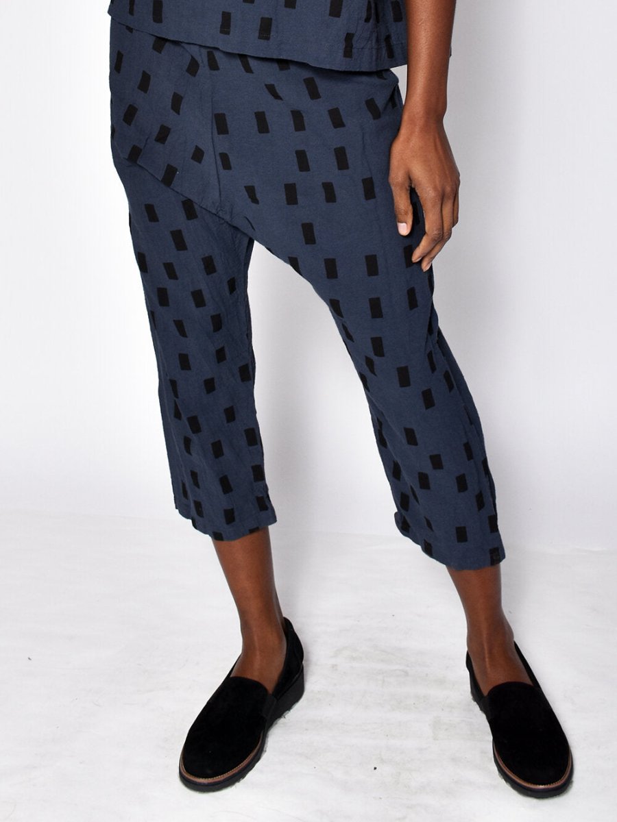 Loose fitting straight leg cropped navy blue pants with black square pattern. Designed and sewn by Uzi in Brooklyn, New York.