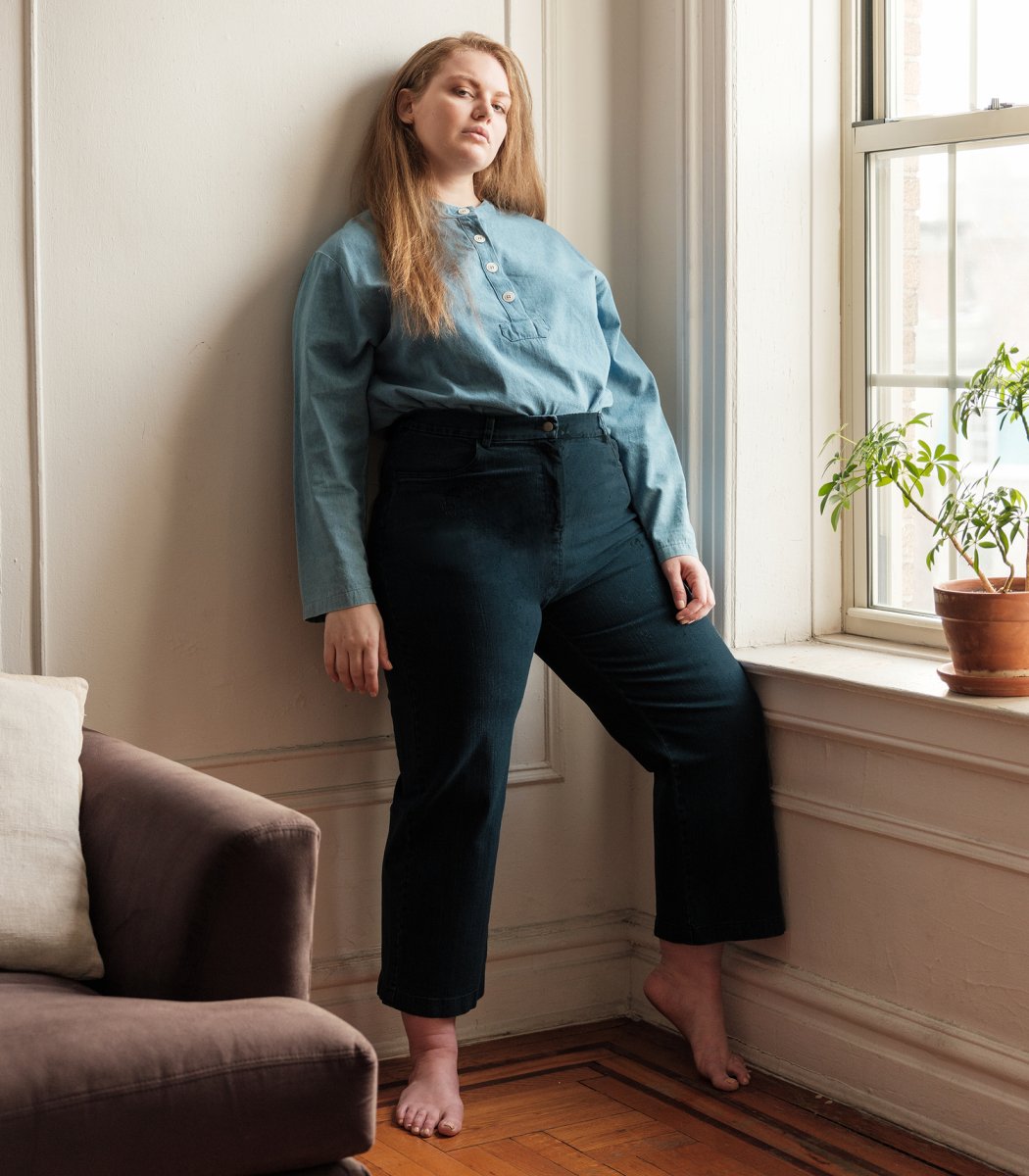 Model wears a straight leg jean in a dark indigo wash. The Parker jeans in Dark Indigo are designed by Loup and made in New York City, USA.