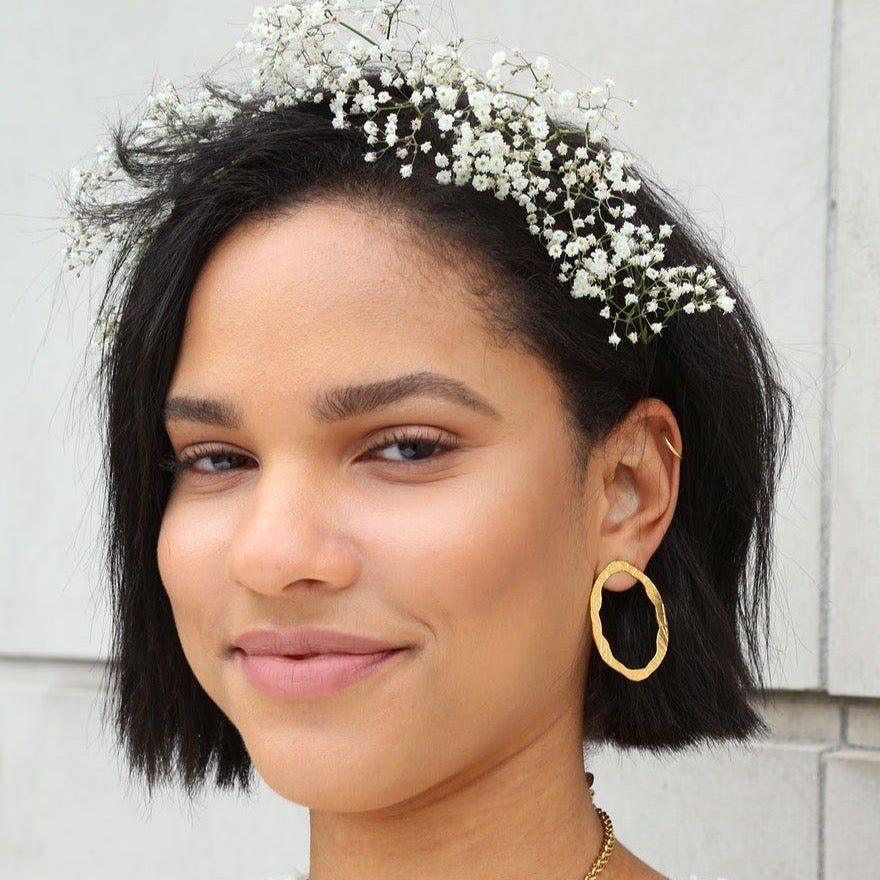 A 22kt gold plated stud earring. The Portal of Faith Earrings are designed and handcrafted by Lingua Nigra in Chicago, Illinois.