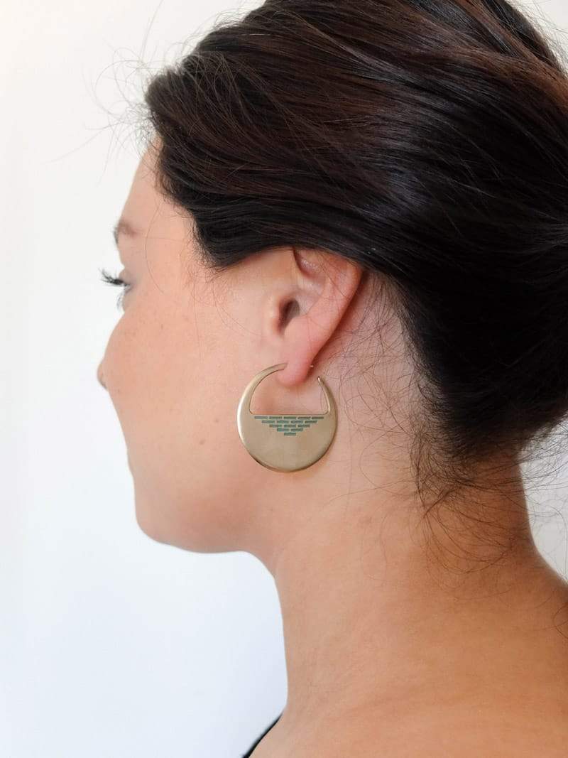 Bronze and aqua paint Portsmouth hoop earrings, pictured on the profile of a model wearing her hair in a ponytail.