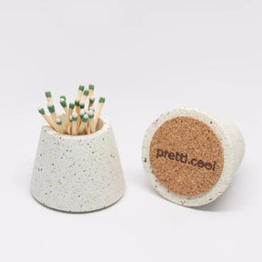 Two terrazzo concrete matchstick holders with cork bottoms in the shade white. Made by Pretti.Cool in Houston, Texas.