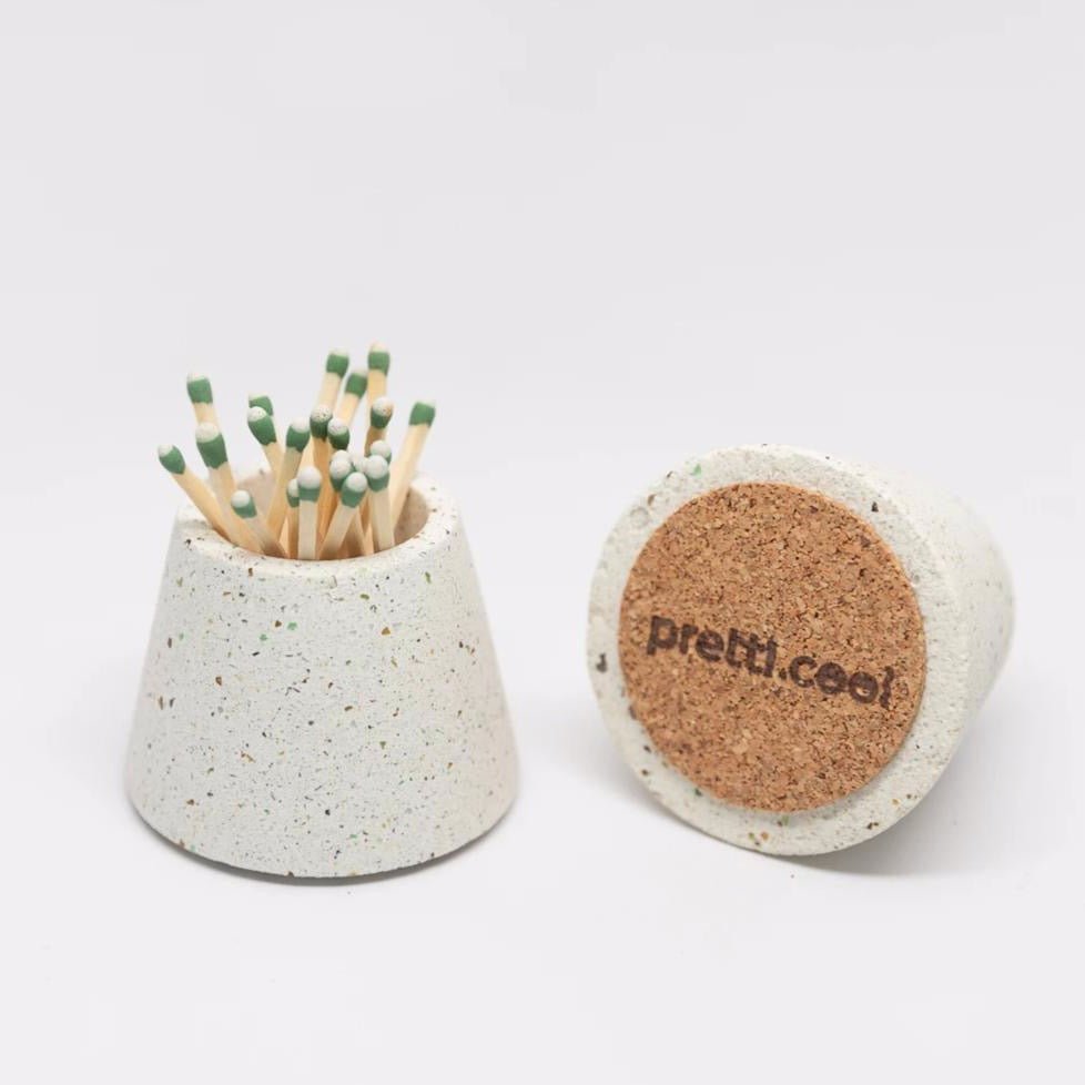 Two terrazzo concrete matchstick holders with cork bottoms in the shade white. Made by Pretti.Cool in Houston, Texas.