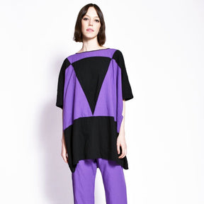 A purple and black tunic style dress with a color blocked triangle design. The Triangle Dress in Purple is designed and sewn by Uzi in Brooklyn, New York.
