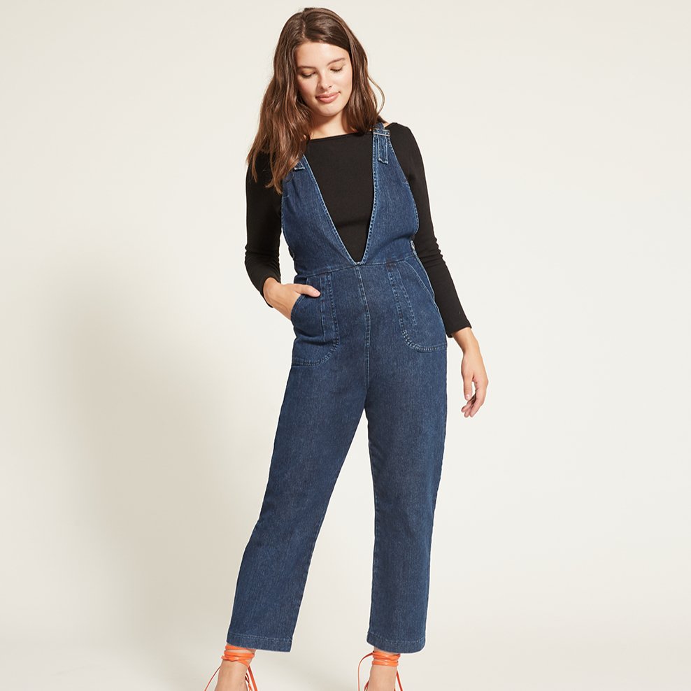 Model wears the Rhoda Coveralls in Indigo over a black long sleeved shirt. The Rhoda Coveralls in Indigo are designed by Loup and made in New York City, USA.