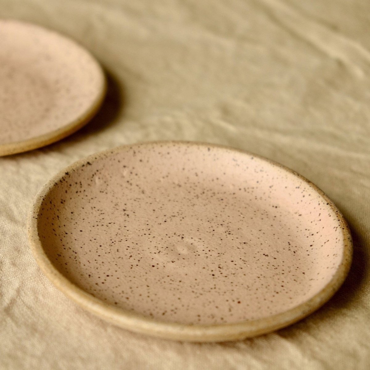 Wheel thrown ceramic ring dish with an interior blush pink matte glaze finish. Designed and handmade by Sunflower Studio in Portland, Oregon.