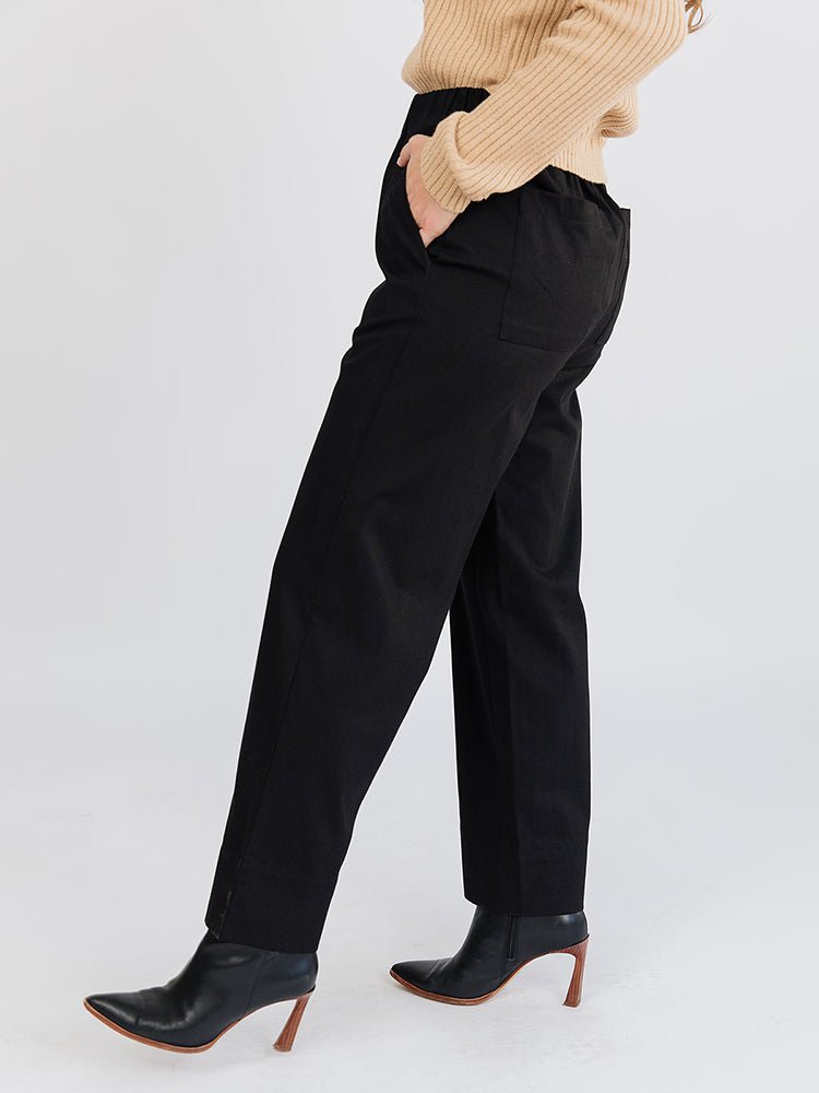 A side profile of a straight leg loose denim pant in black with an elastic waist. The Rosie Pant in Black Denim is designed by Mata Traders and made in India.