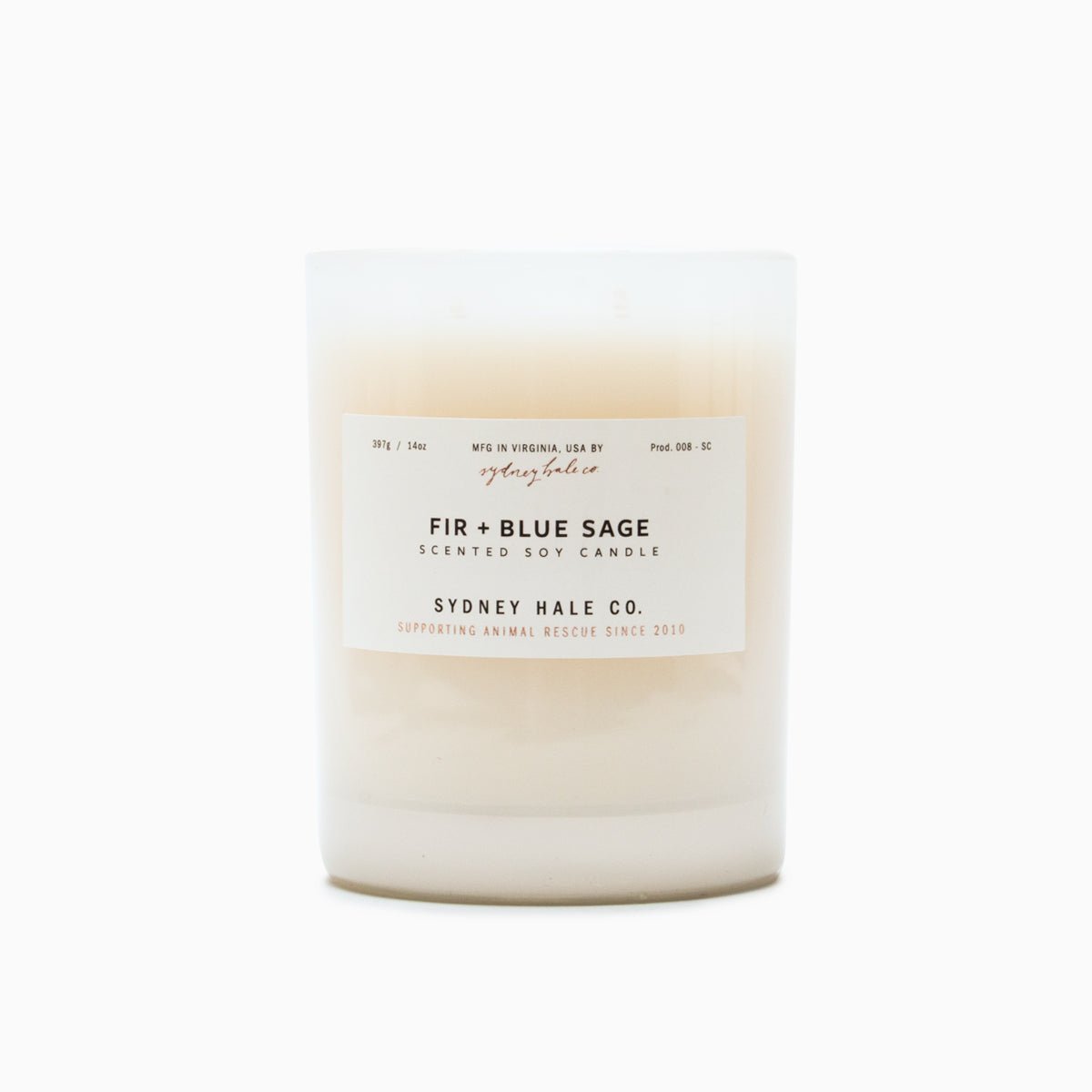 A cylindrical glass candle filled with a soy wax blend and two double cotton wicks. Label reads: "397g/14 oz. Manufactured in Virginia, USA by Sydney Hale Co. Fir + Blue Sage scented soy candle. Sydney Hale Co. Supporting Animal rescue since 2010." 