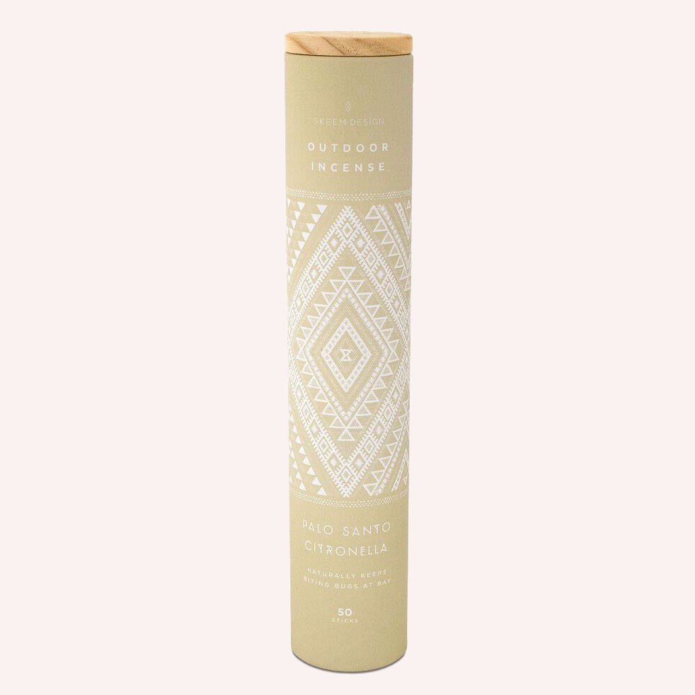 Tan colored cylindrical shaped packaging with white colored diamond design. Contains fifty citronella outdoor incense sticks in the scent palo santo. Made in Philadelphia, PA by SKEEM Design.