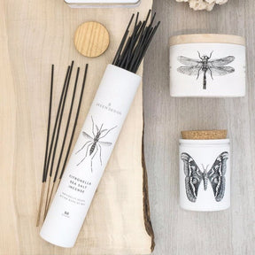 White cylindrical shaped packaging with a black insect design. Contains fifty citronella outdoor incense sticks in the scent sea salt. Made in Philadelphia, PA by SKEEM Design.