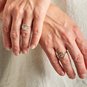 Model wears the Sano (0.25 carat) and Apricus rings on their left hand. They wear the Sano (0.6 carat) and Altus rings on their right hand.