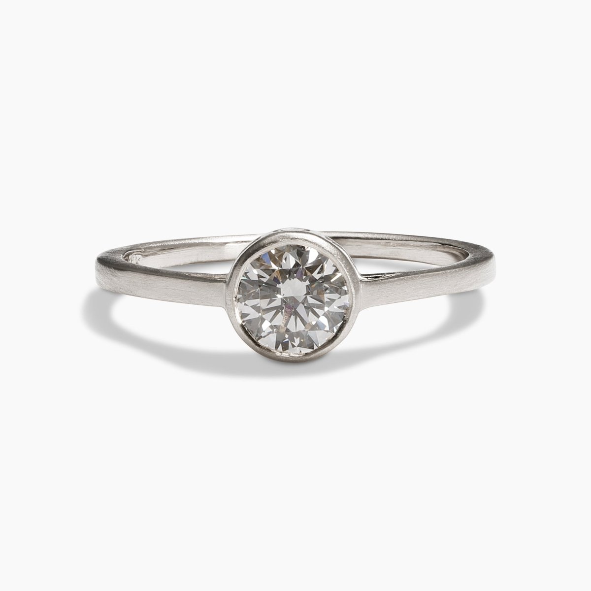 Sano ring from Betsy & Iya in a 14K recycled white gold band with two accent diamonds inset on the side and a central round brilliant cut lab-grown diamond (0.6 ct).