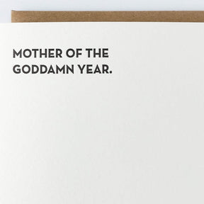 Kraft card with black text that reads: "MOTHER OF THE GODDAMN YEAR." Comes with a brown Kraft envelope. Designed by Sapling Press and made in Pittsburgh, PA.