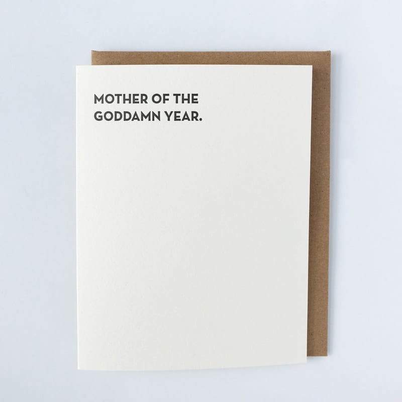 Kraft card with black text that reads: "MOTHER OF THE GODDAMN YEAR." Comes with a brown Kraft envelope. Designed by Sapling Press and made in Pittsburgh, PA.