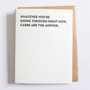 Kraft card with black text that reads: "WHATEVER YOU'RE GOING THROUGH RIGHT NOW, CARBS ARE THE ANSWER." Designed and made by Sapling Press in Pittsburgh, PA.