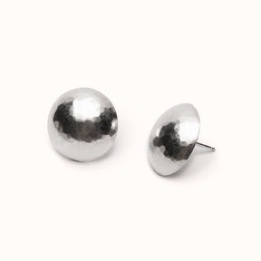 A circular and rounded hand hammered sterling silver stud earring. The Sentia Earrings are designed and handcrafted in Portland, Oregon.