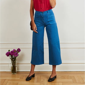 A model wears a high waisted wide legged cropped light blue pant. The Simone Jean in Azure is designed by Loup and made in New York City, USA.