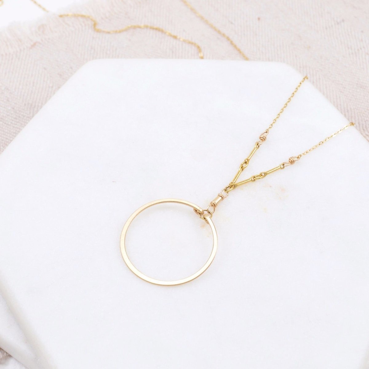 A single gold-fill hoop is suspended by a gold-fill links and chain. The Single Circle Necklace in Gold is designed and handmade by Amy Olson.