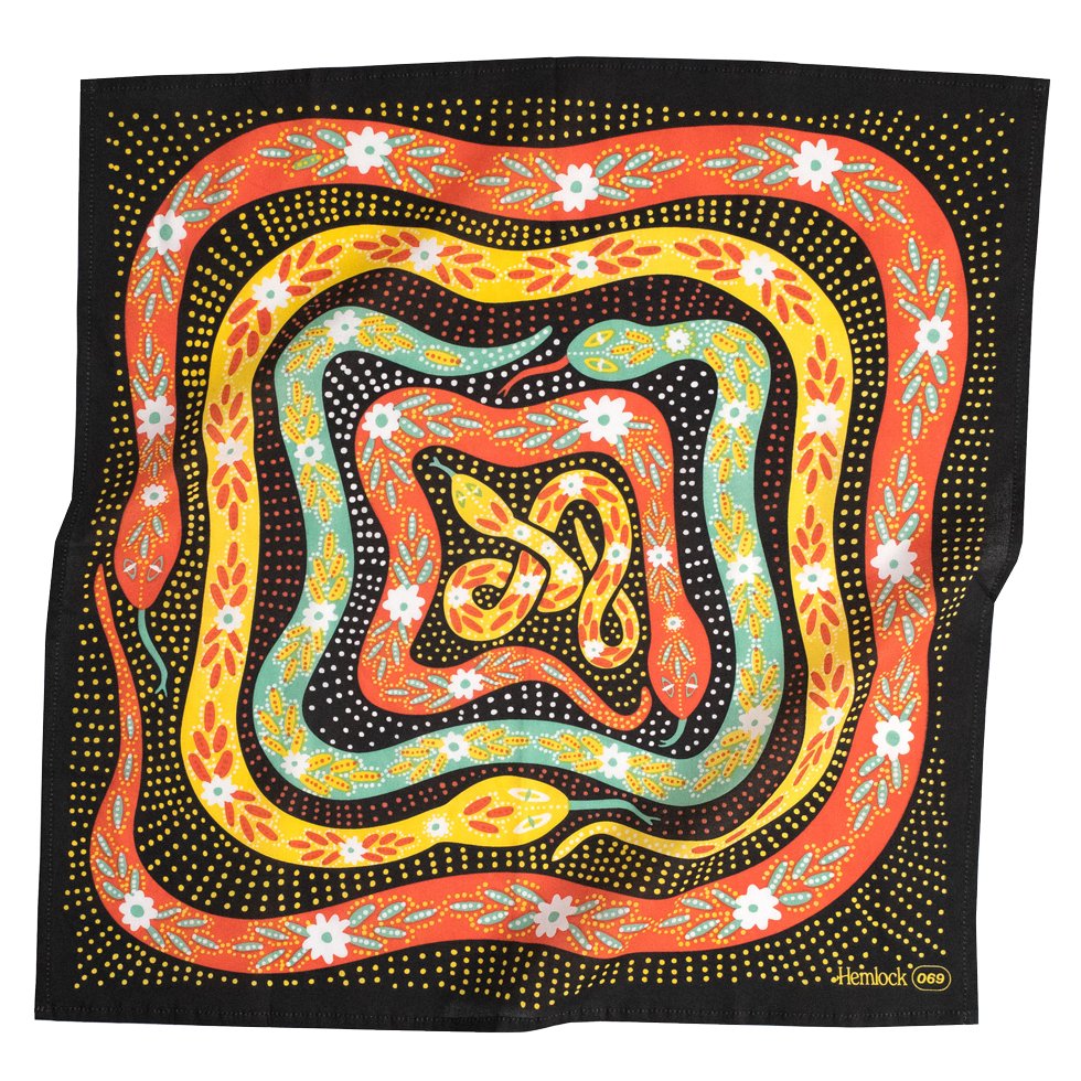 A black, yellow, orange, white, blue bandana in a floral snake pattern. designed by Hemlock Goods in Fulton, MO and screen printed by hand in India.