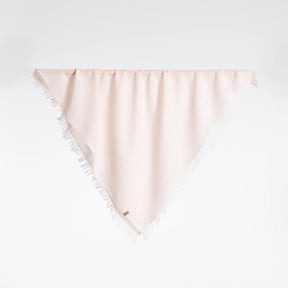A square scarf made of 100% Merino wool in a light pink color. The Merino Square Woven Scarf in Blush Pink is designed by Dinadi and handcrafted in Nepal.