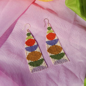 Green, red, purple, orange and cream colored woven beaded fringe earrings. Designed and handmade by Take Shape Studio in Berkeley, California.