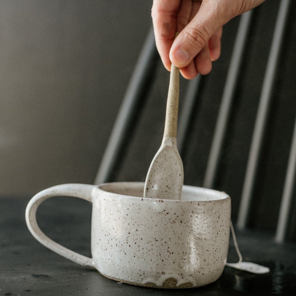 Stirring spoon made with stoneware clay with a glossy white speckled finish. Designed and hand built by Amy A Ceramics in Portland, Oregon.
