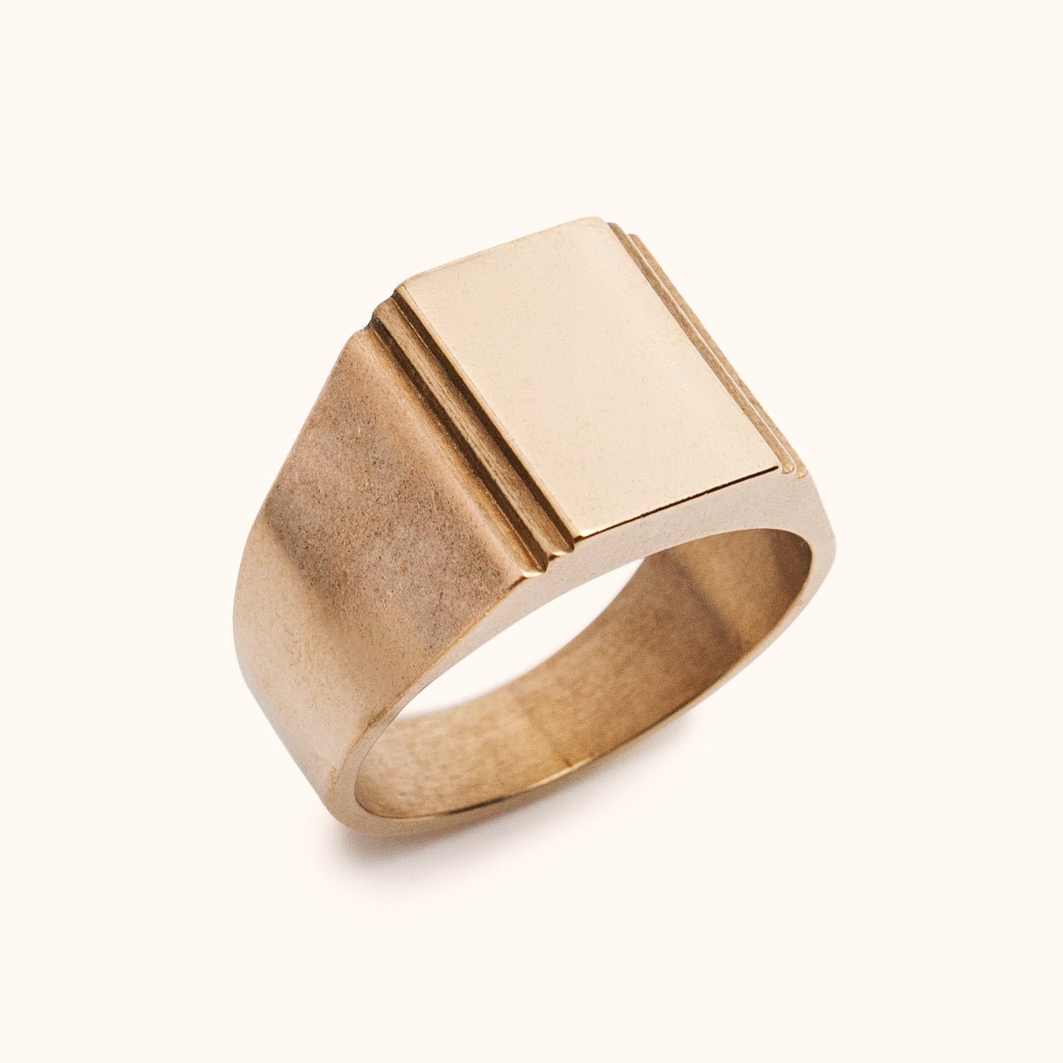 A wide bang rectangular signet ring with a stair step cut out design. Made of Bronze. The Suscita Ring is designed and handcrafted in Portland, Oregon.