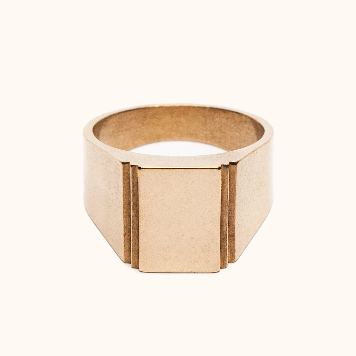 A wide bang rectangular signet ring with a stair step cut out design. Made of Bronze. The Suscita Ring is designed and handcrafted in Portland, Oregon.