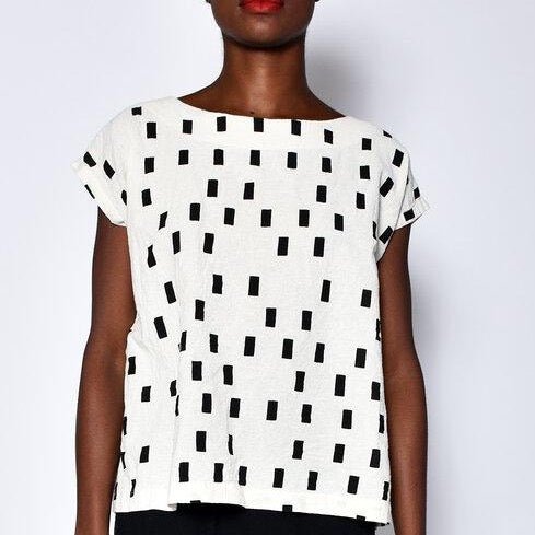 Cream colored short sleeve tunic with black square pattern. Designed and sewn by UZI in Brooklyn, New York.